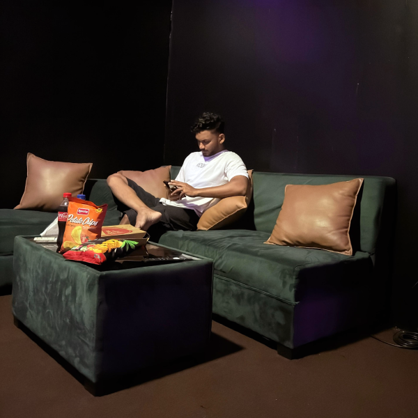 Guest relaxing on a sofa in a private cinema room
